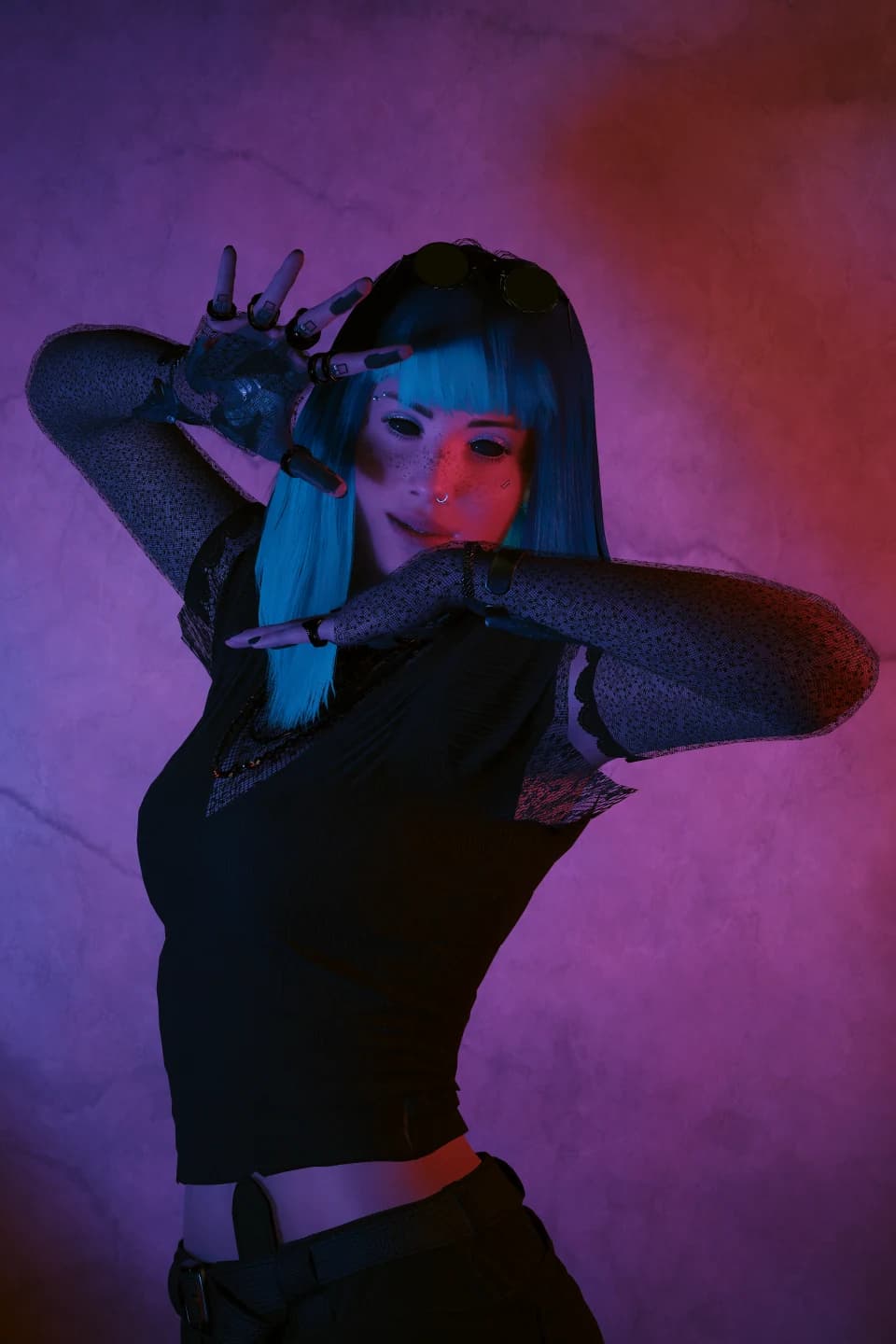 Neon Session — blue hair, arms raised, magenta pink lighting, black outfit